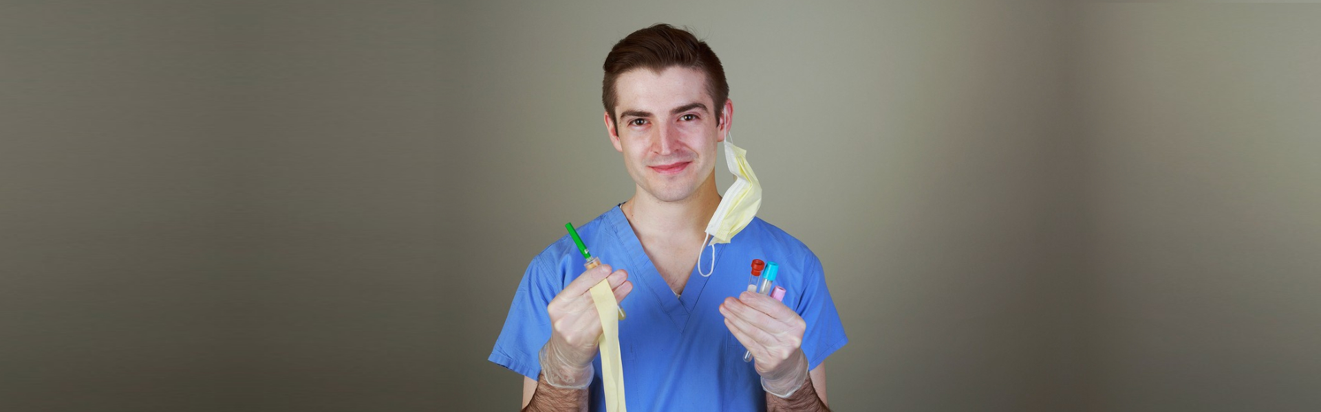 Young male phlebotomist with equipment for drawing blood